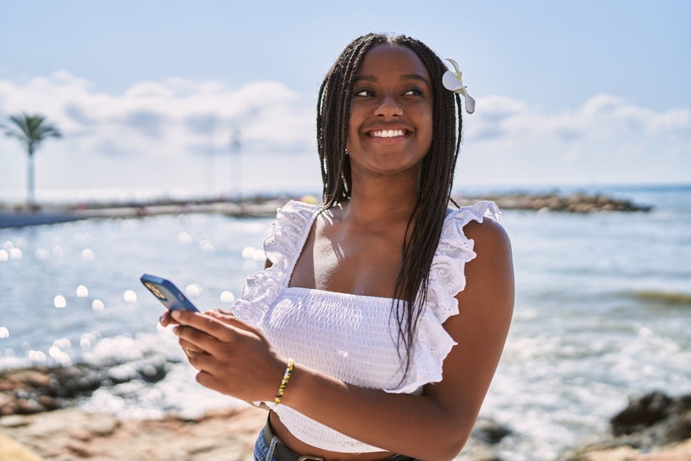 Guest using Destinely on her phone to browse local experiences after booking